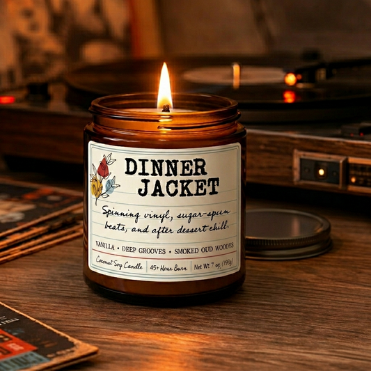 Dinner Jacket coconut soy candle burning in amber jar on wooden table beside record player and record albums